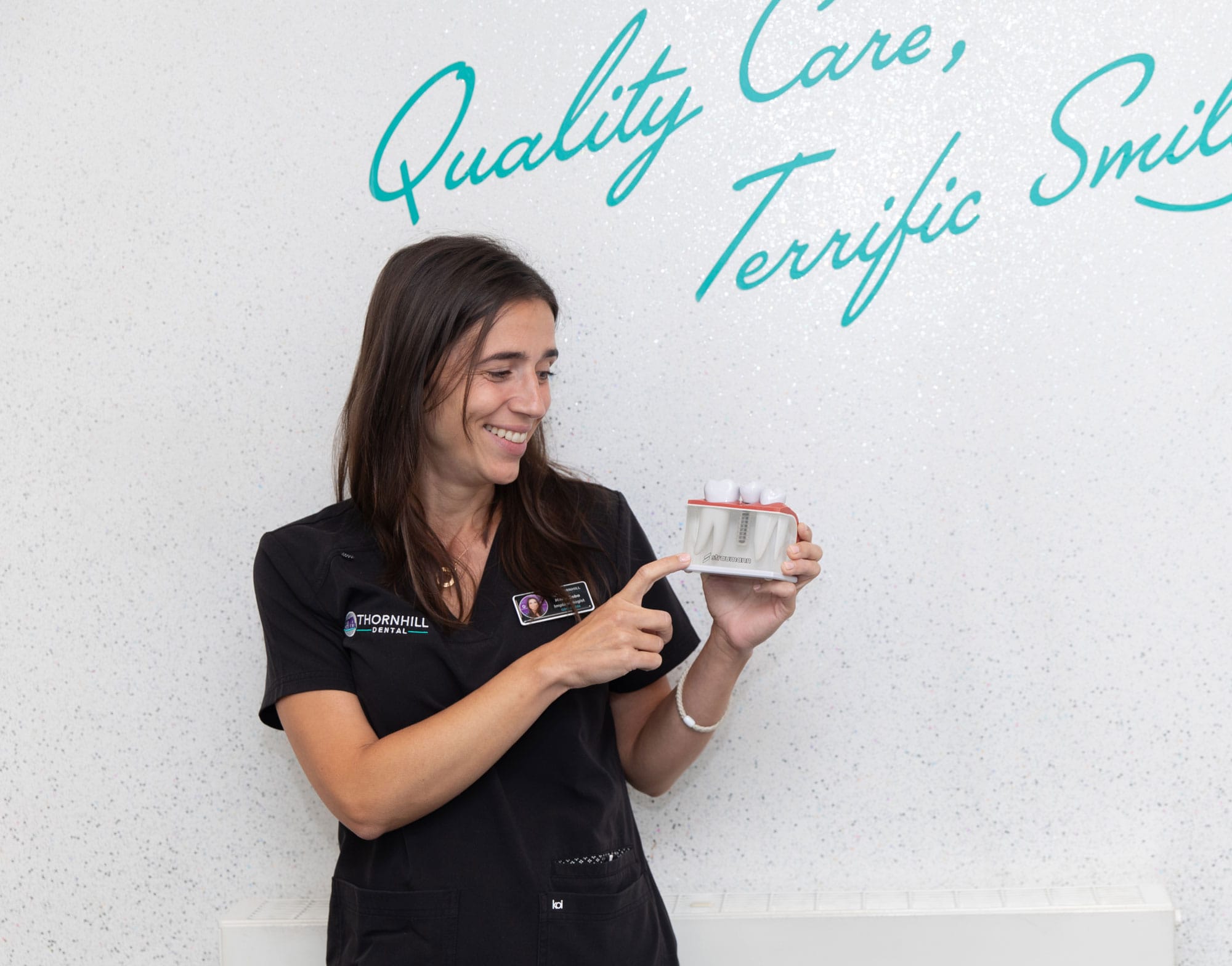 Maria Cobo with dental implant model