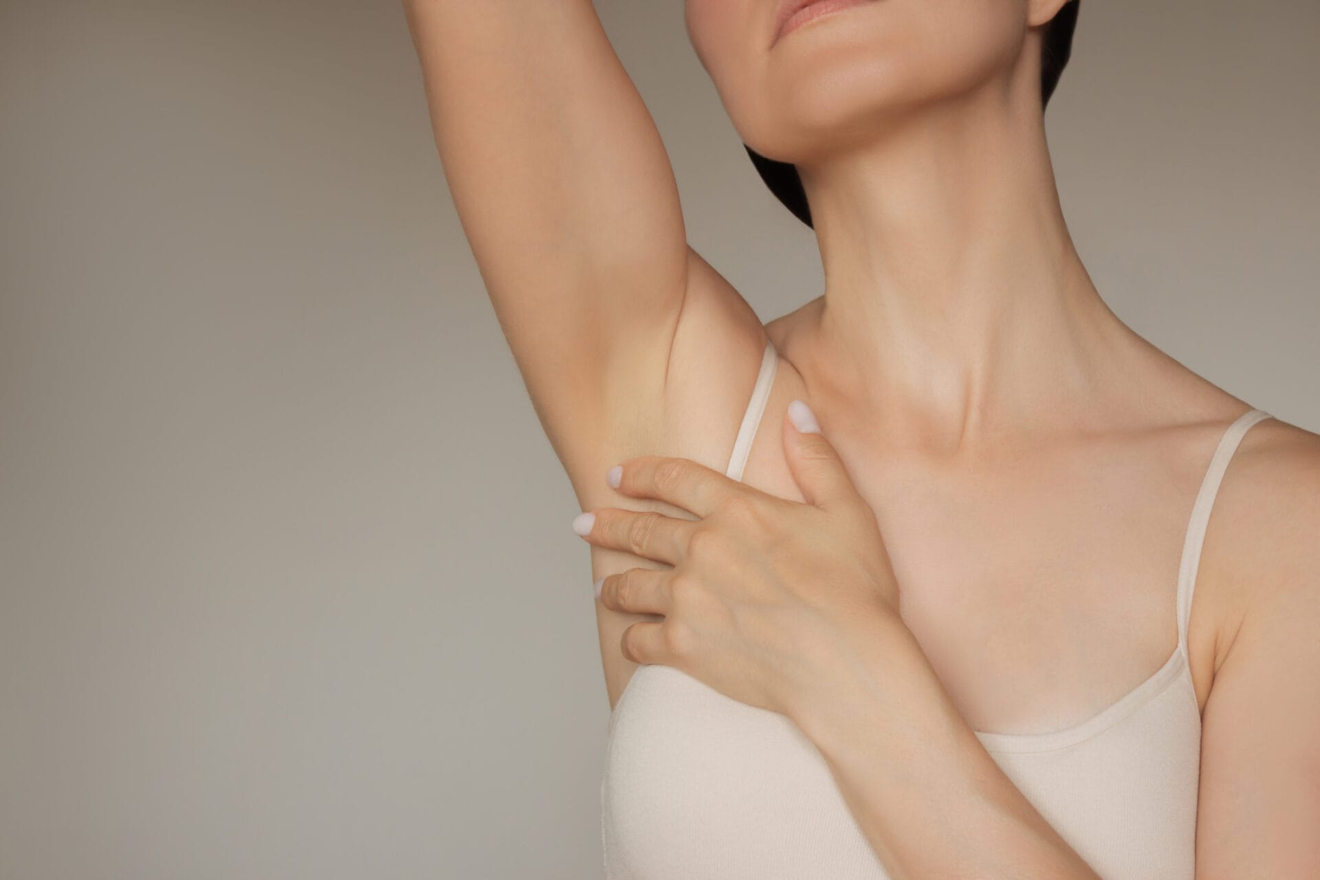 Woman gently touching her smooth armpits
