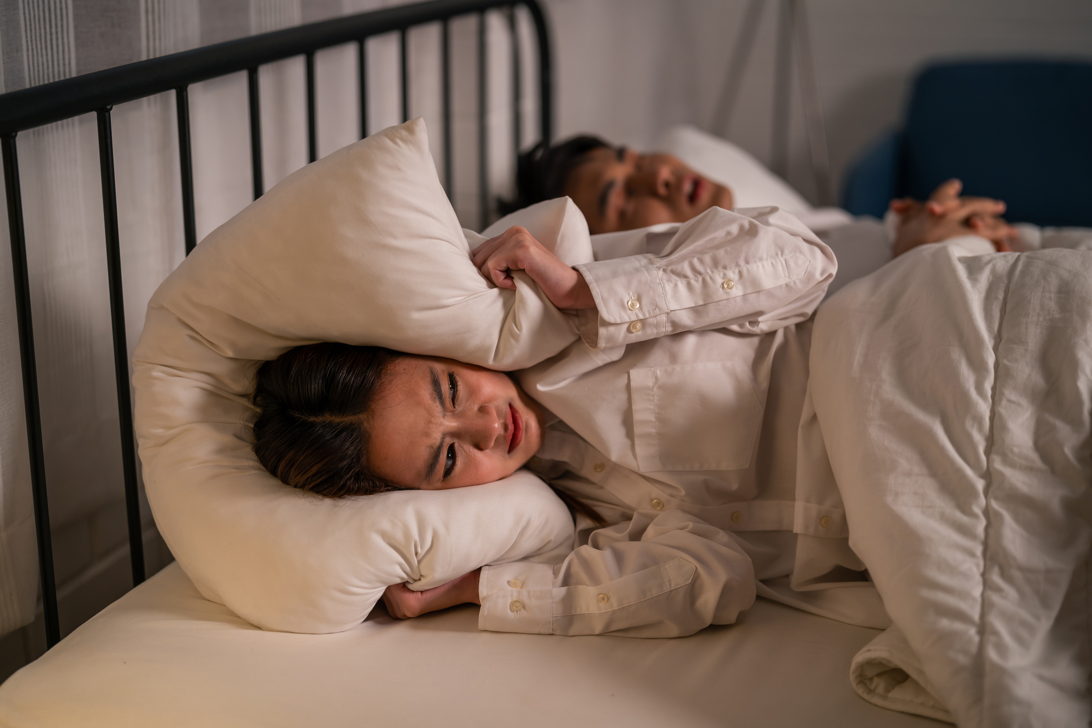 Woman feel frustrated from husband snoring while sleep